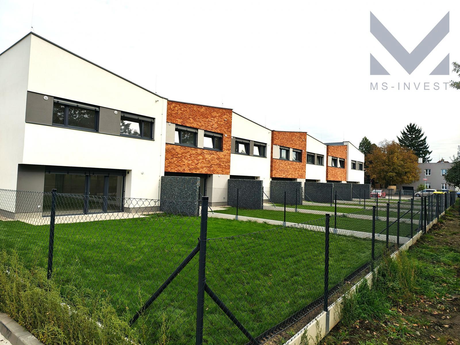 Zahrady za domy řady K s položeným travním kobercem.jpg