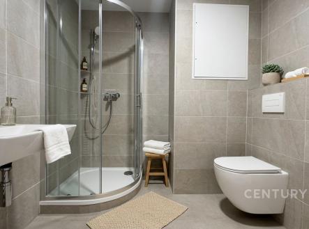 Moderní koupelna s dlažbou, sprchovým koutem a závěsnou toaletou, elegantní design a světlé provedení nabízejí komfort a styl. | Pronájem bytu, 1+kk, 34 m²
