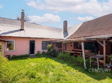 Zahrada s travnatým pozemkem u rodinného domu, s terasou a rozšířeným křídlem, vhodná pro rekonstrukci. Dominantní jsou tradiční střešní krytiny. | Prodej - dům/vila, 366 m²