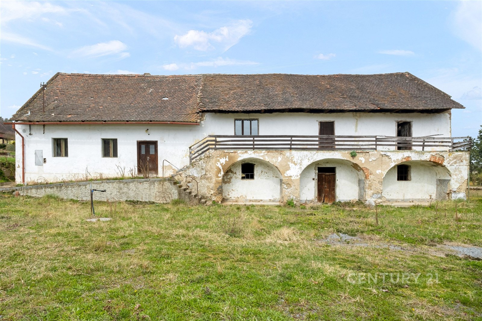 Stará venkovská budova s kamennými schody a původní omítkou, vhodná k rekonstrukci. Prostorný pozemek s možností rozvoje. 