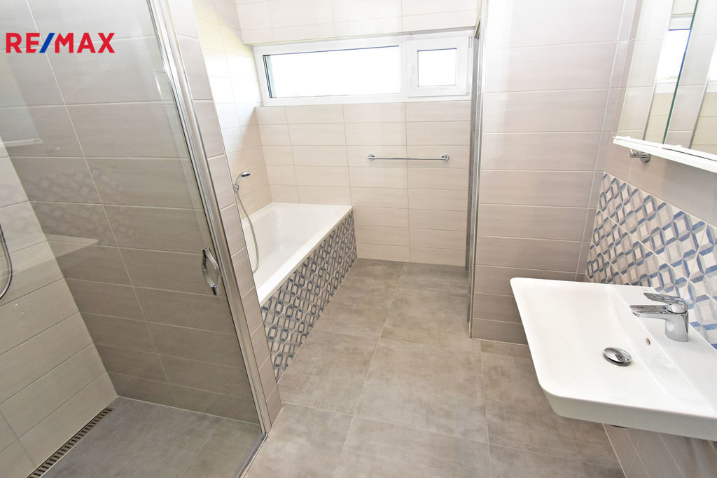 Koupelna se sprchovým koutem, vanou, umyvadlem a technickou místností včetně plynového kotle.