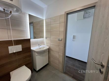 Malá koupelna s moderní dlažbou, světlý obklad, sanitární zařízení včetně umyvadla a toalety, čistý a udržovaný prostor. | Pronájem bytu, 1+1, 37 m²