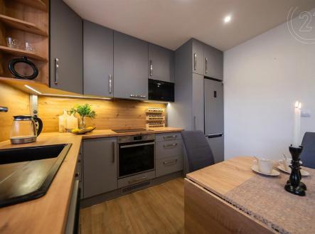 kuchyně s trouba, dřevěná podlaha, backsplash, deformace, a šedé skříňky | Prodej bytu, 3+kk, 60 m²