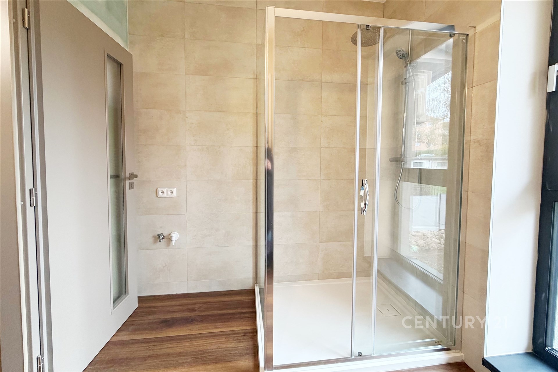 Koupelna se sprchovým koutem, moderní design, dlažba na stěnách, velké okno, parketová podlaha, světlá atmosféra