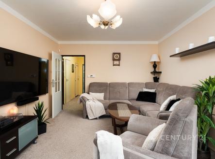 Prostorný obývací pokoj s moderním nábytkem, světlý interiér, koberec a velká TV, elegantní dekorace a pohodlná sedací souprava | Prodej bytu, 4+1, 95 m²