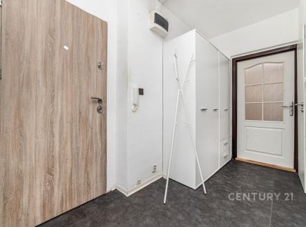 Vstupní hala s dlažbou, vestavěné skříně a moderní dveře, nabízí praktické úložné prostory a elegantní design. | Prodej bytu, 1+1, 40 m²