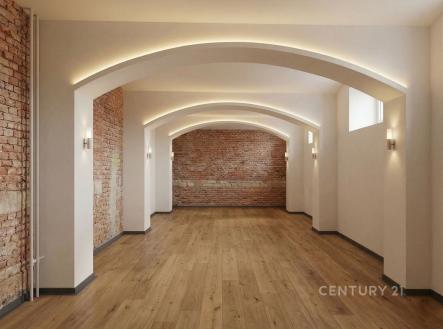 Prostorný obývací pokoj s parketovou podlahou, moderní osvětlení, cihlové zdi dodávají industriální styl, vhodný pro rekonstrukci. | Prodej - kanceláře, 79 m²